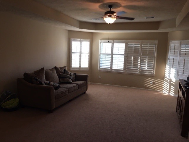 Example of a mid-sized classic enclosed carpeted game room design in Houston with beige walls, no fireplace and a tv stand