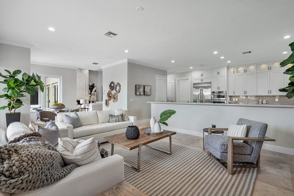 Living room - coastal open concept gray floor living room idea in Miami with gray walls