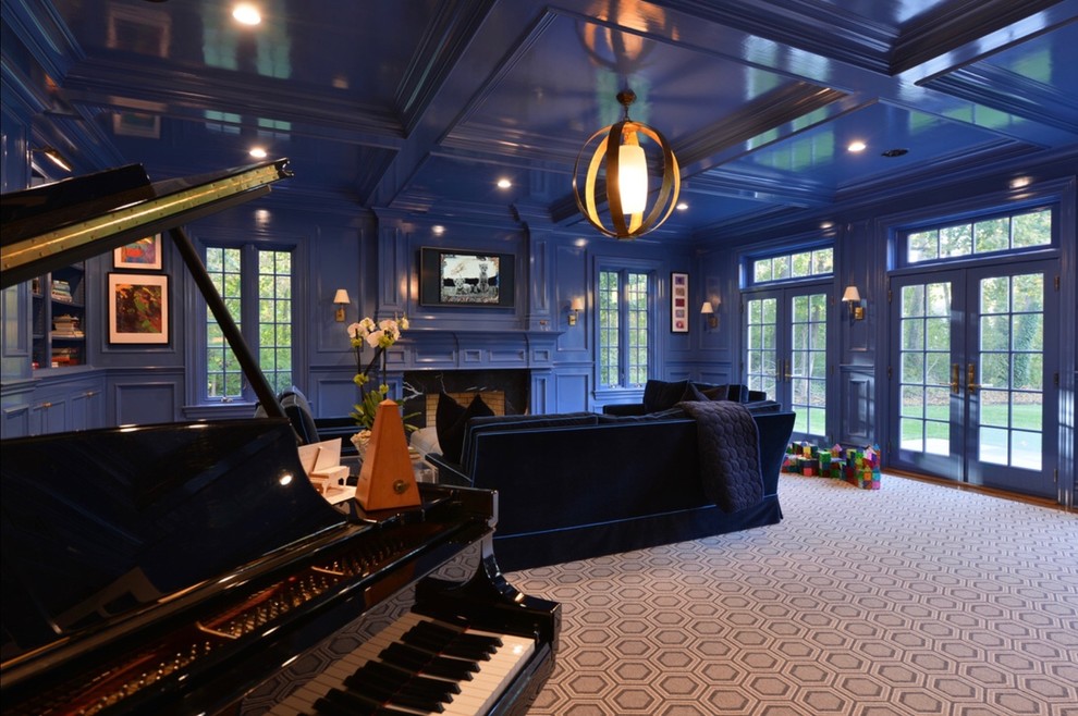 Example of a huge classic enclosed carpeted and gray floor family room design in New York with blue walls, a standard fireplace, a stone fireplace and a wall-mounted tv