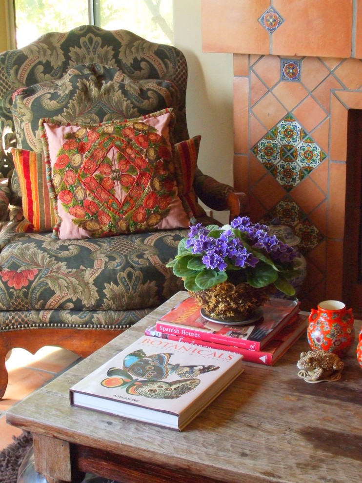 Foto de sala de estar abierta mediterránea de tamaño medio con paredes beige, suelo de baldosas de terracota, marco de chimenea de baldosas y/o azulejos y suelo naranja