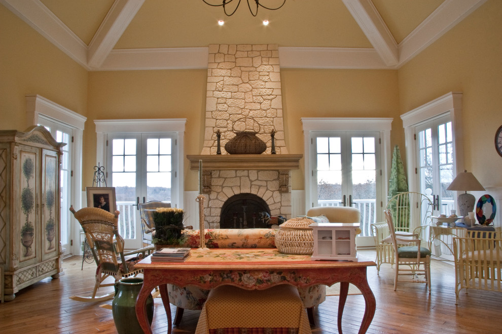 Inspiration for a huge timeless enclosed medium tone wood floor family room remodel in Grand Rapids with beige walls, a standard fireplace and a stone fireplace