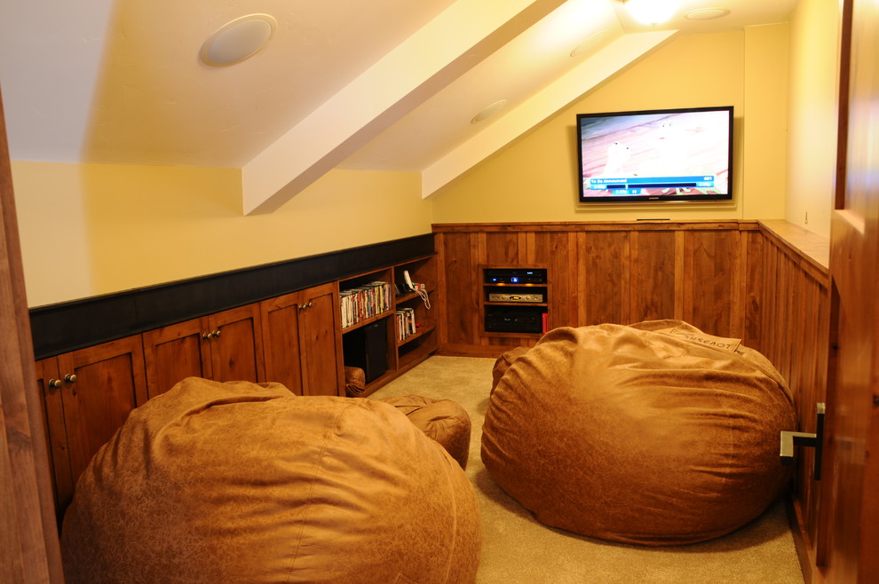 This is an example of a medium sized rustic enclosed games room in Denver with a game room, beige walls, carpet and a built-in media unit.