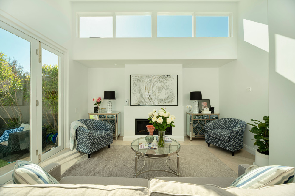 На фото: открытая гостиная комната среднего размера в современном стиле с белыми стенами, светлым паркетным полом, телевизором на стене и бежевым полом
