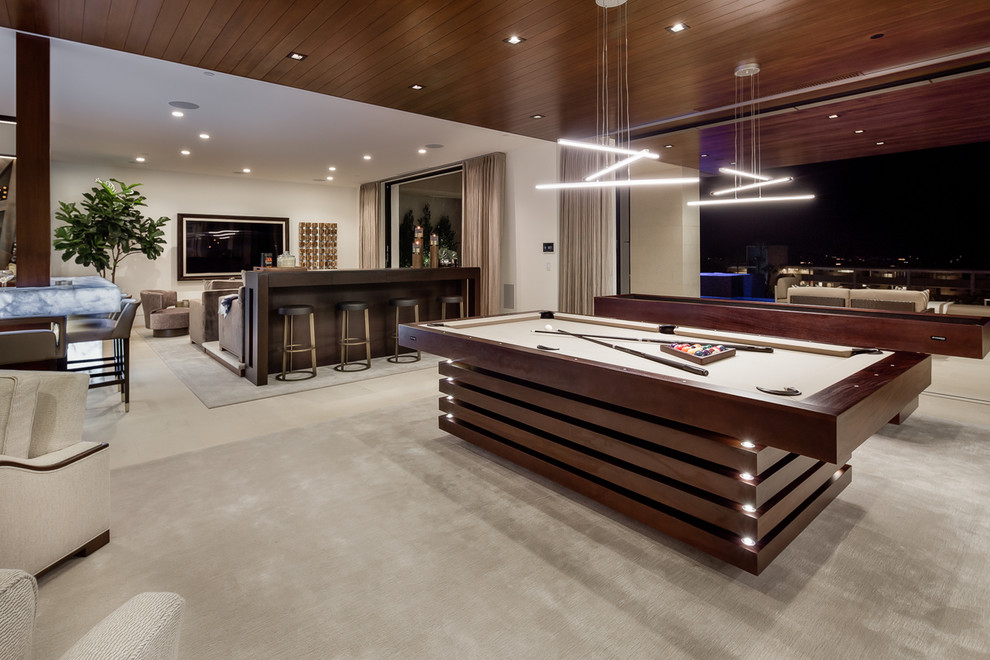 Inspiration for an expansive contemporary open plan games room in Orange County with a game room, white walls, carpet, no fireplace, a wall mounted tv and beige floors.