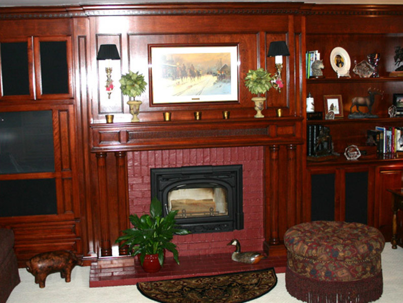 Example of a trendy open concept carpeted family room design in Orange County with red walls, a standard fireplace, a brick fireplace and a media wall
