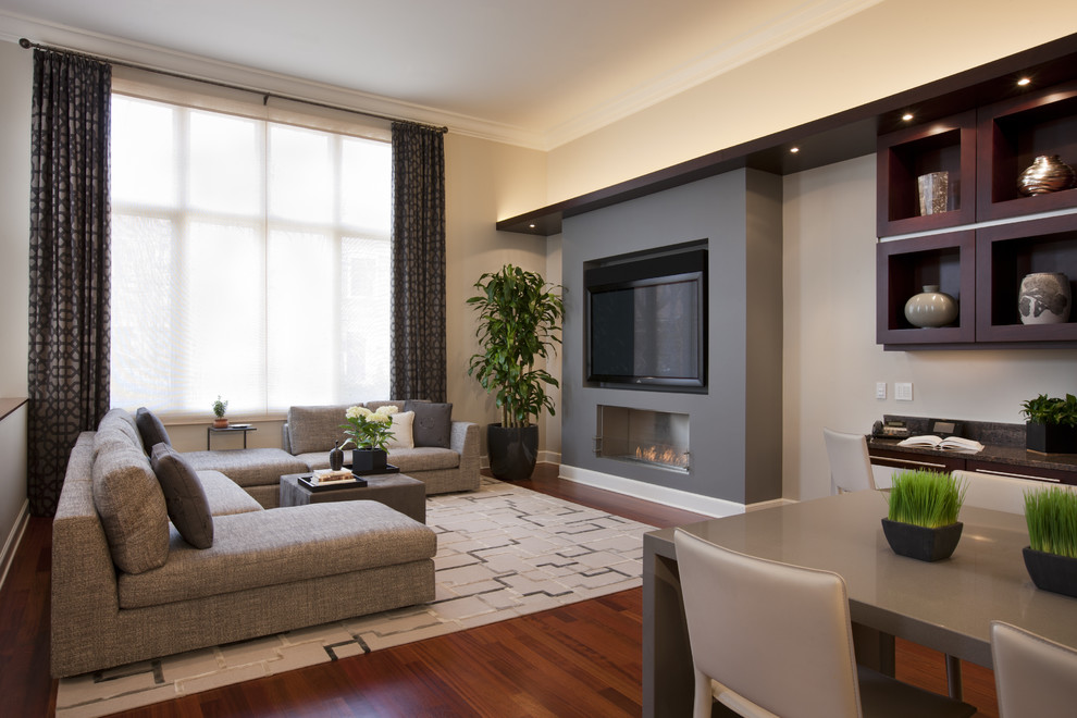 Inspiration for a contemporary games room in Chicago with beige walls, dark hardwood flooring, a ribbon fireplace and a freestanding tv.