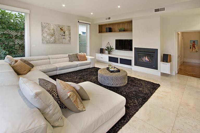 Idee per un soggiorno vittoriano con pavimento in pietra calcarea, camino classico, cornice del camino in metallo e TV a parete
