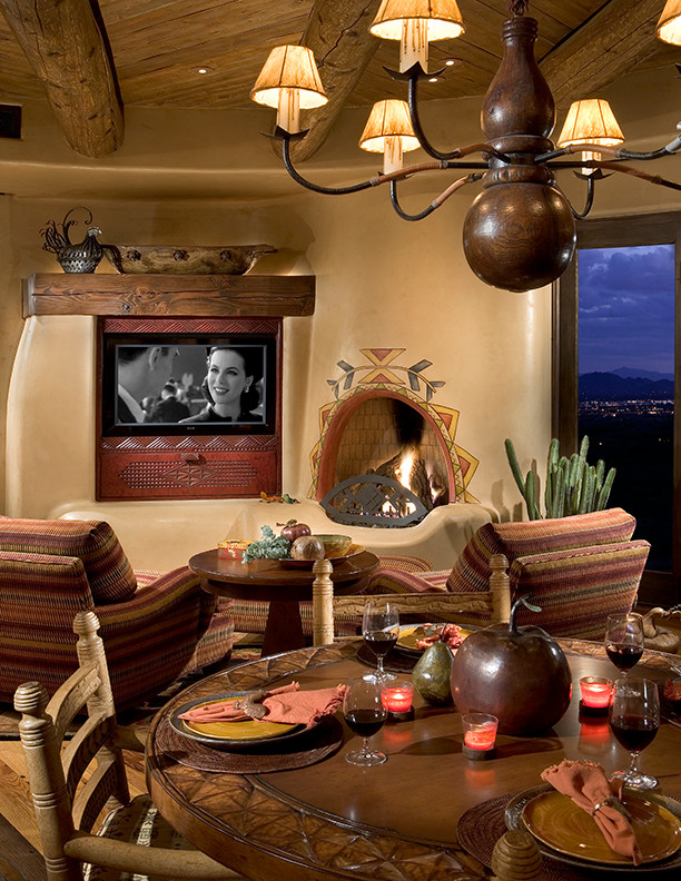 Example of a large southwest open concept medium tone wood floor family room design in Phoenix with beige walls, a standard fireplace, a plaster fireplace and a media wall
