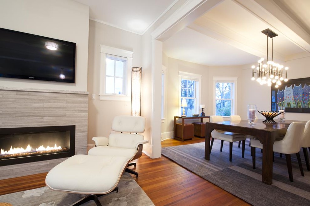 Inspiration for a mid-sized transitional open concept medium tone wood floor and brown floor family room remodel in New York with beige walls, a ribbon fireplace, a wall-mounted tv and a stone fireplace