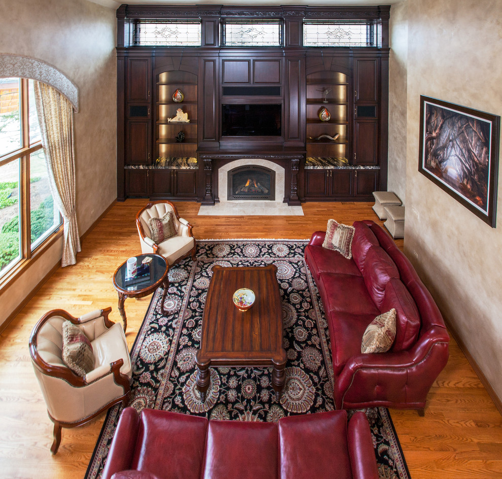 Design ideas for a large traditional enclosed games room in Chicago with beige walls, medium hardwood flooring, a standard fireplace, a stone fireplace surround and a built-in media unit.