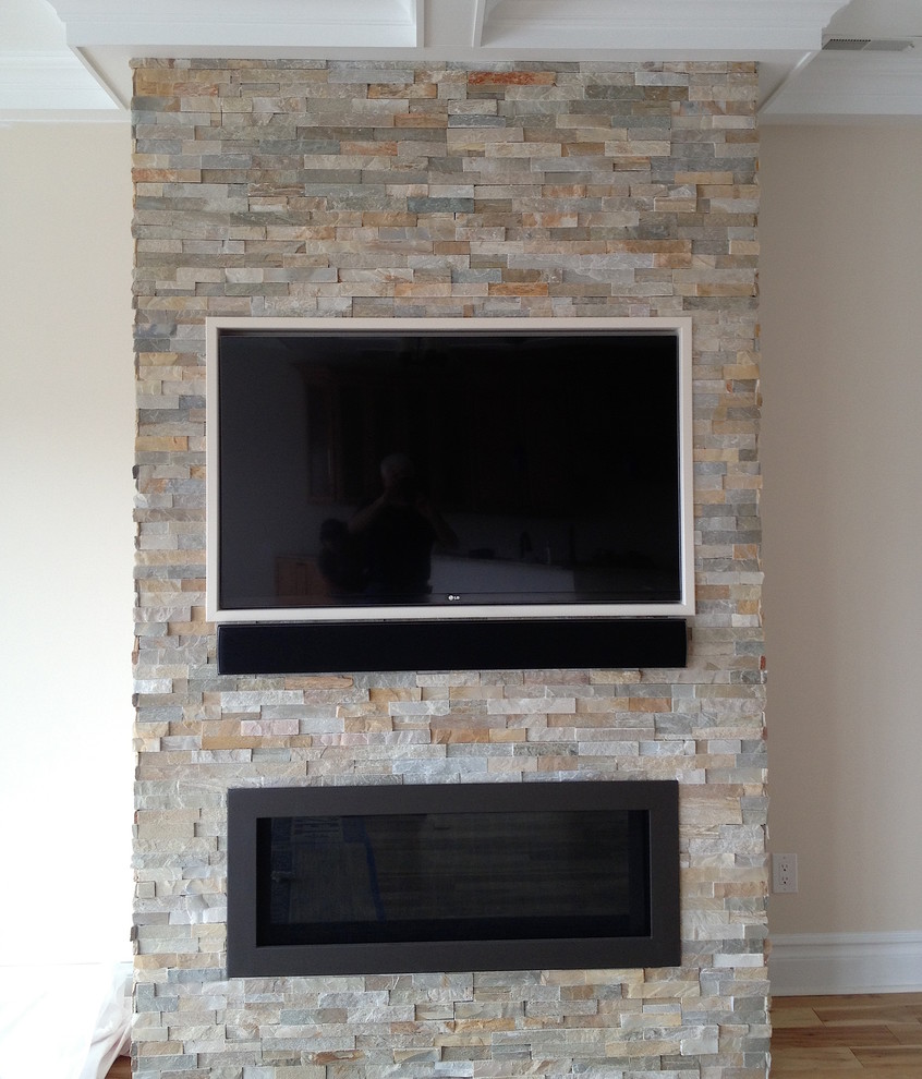 This is an example of a medium sized contemporary enclosed games room in Philadelphia with beige walls, medium hardwood flooring, a ribbon fireplace, a stone fireplace surround and a wall mounted tv.