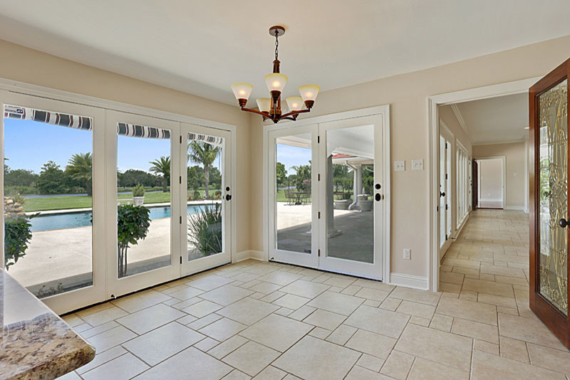 Example of a classic travertine floor and beige floor family room design in New Orleans