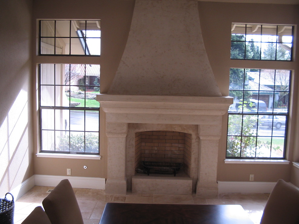 Example of a mid-sized classic enclosed ceramic tile and beige floor family room design in San Francisco with beige walls, a standard fireplace, a stone fireplace and no tv