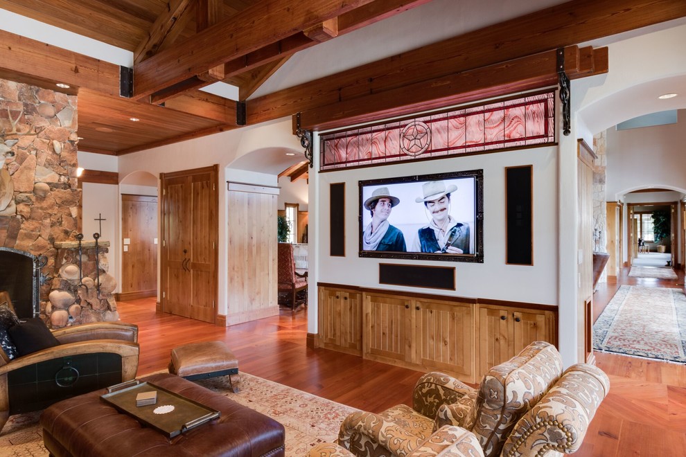 Example of a large southwest open concept medium tone wood floor and brown floor game room design in Philadelphia with white walls, no fireplace and a wall-mounted tv