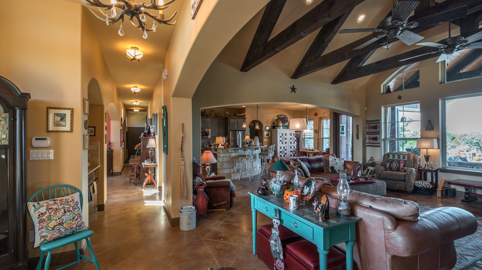 Medium sized open plan games room in Austin with beige walls, terracotta flooring, a corner fireplace, a stone fireplace surround and a freestanding tv.