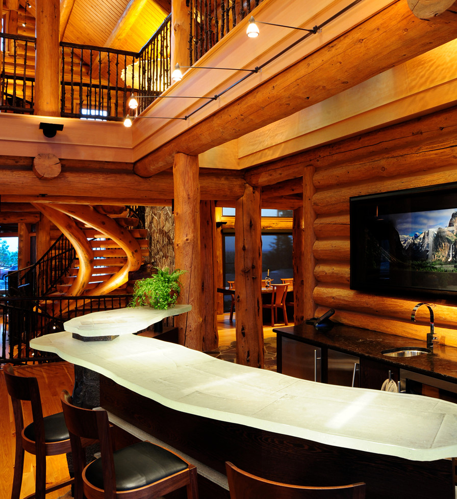 This is an example of a medium sized traditional open plan games room in Seattle with a home bar, brown walls, medium hardwood flooring, a wall mounted tv and brown floors.