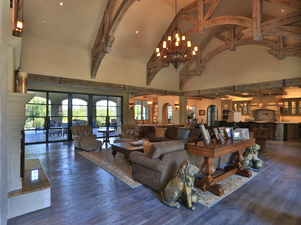 Example of a tuscan family room design in Dallas