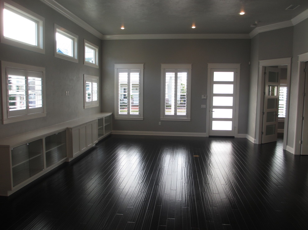 Photo of a medium sized world-inspired open plan games room in Miami with grey walls and a wall mounted tv.