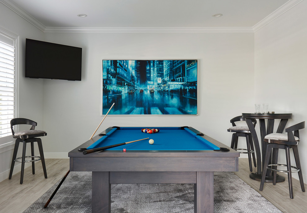 Immagine di un soggiorno chic con sala giochi, pareti grigie, parquet chiaro, porta TV ad angolo e pavimento grigio