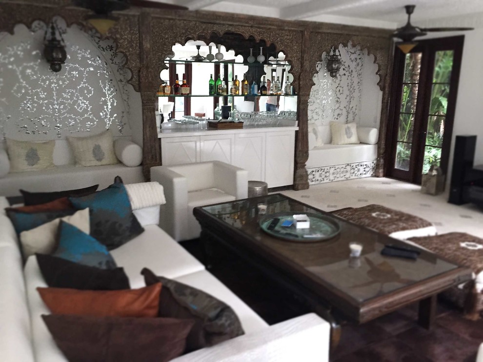 Imagen de sala de estar con barra de bar cerrada mediterránea grande con paredes blancas y suelo de travertino