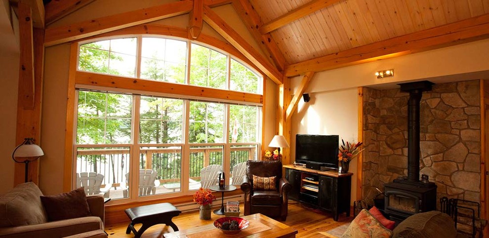 Mid-sized mountain style open concept light wood floor and beige floor family room photo in Ottawa with beige walls, a tv stand, a wood stove and a metal fireplace