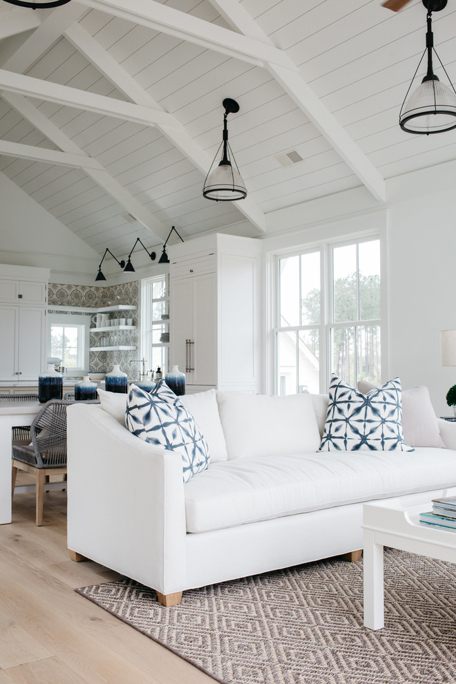 Design ideas for a medium sized nautical open plan games room in Charleston with white walls, light hardwood flooring, a standard fireplace and a stone fireplace surround.
