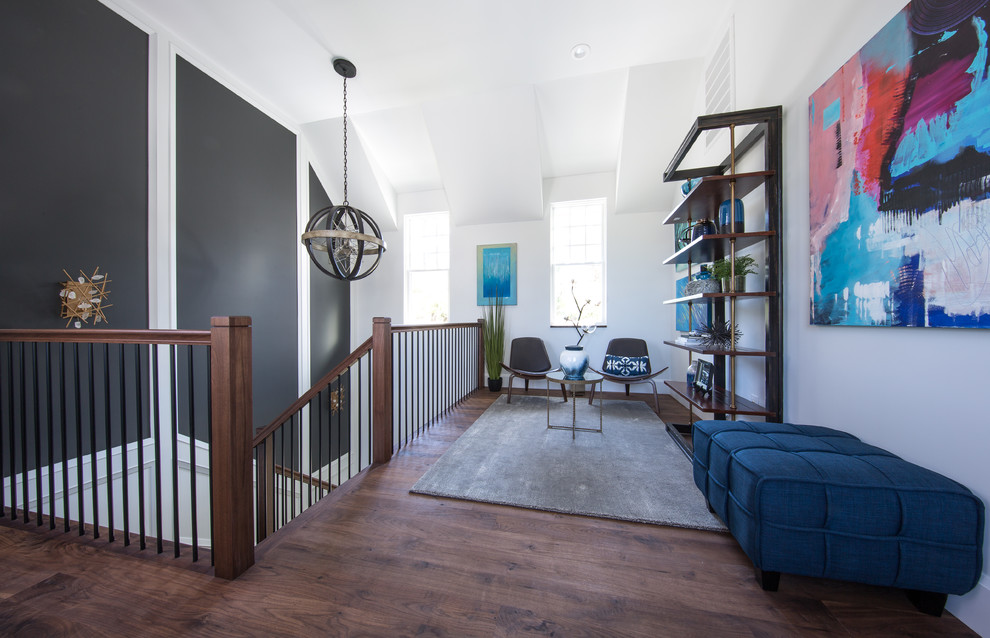 Inspiration for a small transitional loft-style medium tone wood floor and brown floor family room library remodel in Charleston with no fireplace, no tv and white walls