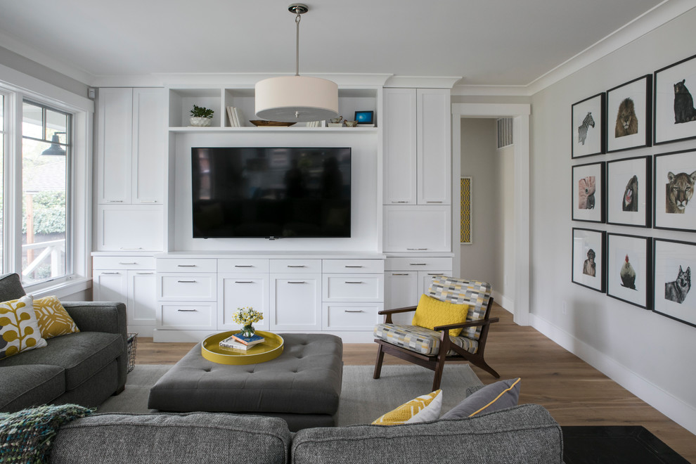Example of a mid-sized transitional open concept light wood floor family room design in San Francisco with gray walls, no fireplace and a wall-mounted tv
