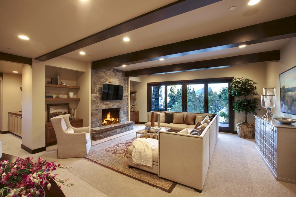 Inspiration for a large transitional enclosed carpeted and beige floor game room remodel in Salt Lake City with beige walls, a standard fireplace, a stone fireplace and a wall-mounted tv