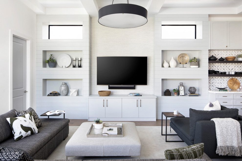 Свежая идея для дизайна: открытая гостиная комната в стиле неоклассика (современная классика) с белыми стенами, паркетным полом среднего тона, телевизором на стене и коричневым полом - отличное фото интерьера