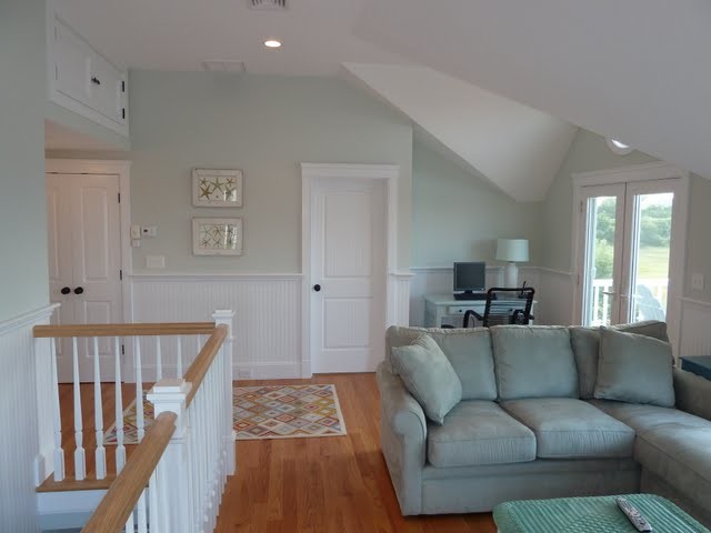 Family room - mid-sized coastal loft-style medium tone wood floor family room idea in Boston with green walls
