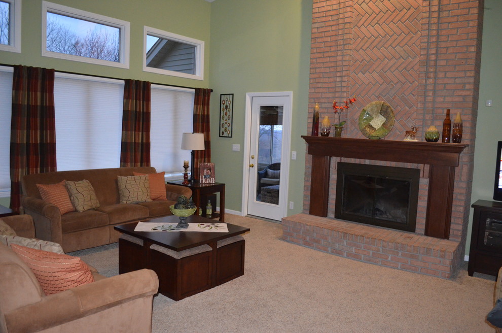 Example of a classic open concept carpeted family room design in Cincinnati with green walls, a standard fireplace, a brick fireplace and a tv stand