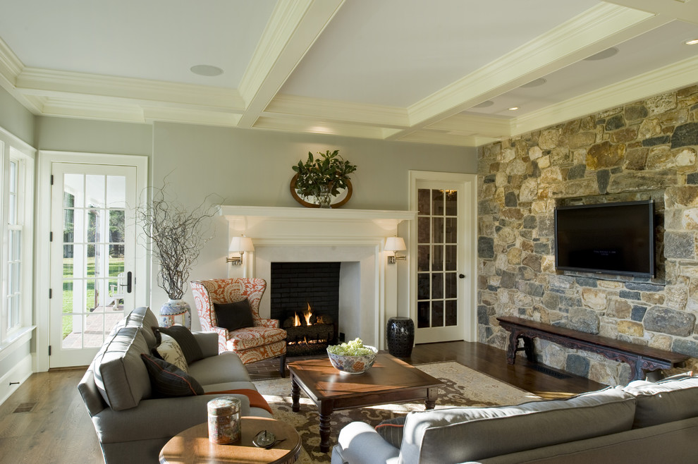 Elegant dark wood floor living room photo in Philadelphia with gray walls, a standard fireplace and a wall-mounted tv