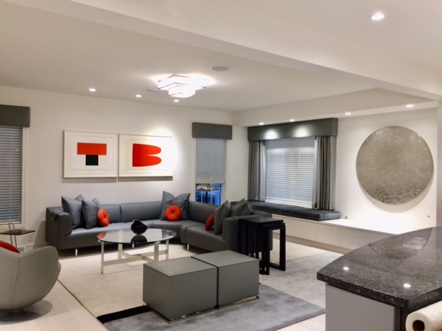 Large modern open plan games room in Philadelphia with a game room, white walls, painted wood flooring, a standard fireplace, a plastered fireplace surround, a built-in media unit and grey floors.