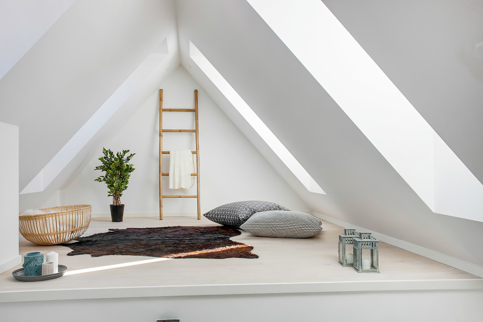Example of a mid-sized danish open concept light wood floor family room design in Copenhagen with white walls