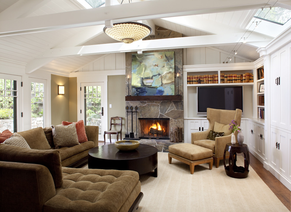 Family room - large contemporary enclosed medium tone wood floor family room idea in San Francisco with a standard fireplace, a stone fireplace and a media wall