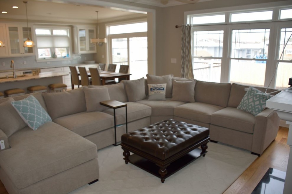 Diseño de sala de estar abierta costera extra grande con suelo de madera clara