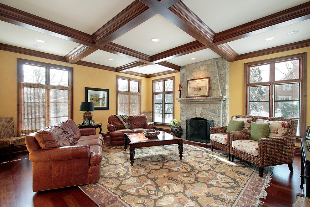 Example of a classic dark wood floor family room design in Chicago with beige walls, a standard fireplace and a stone fireplace