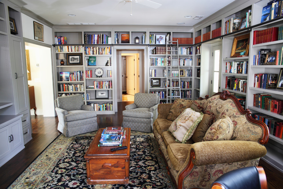 Immagine di un soggiorno classico con libreria e tappeto