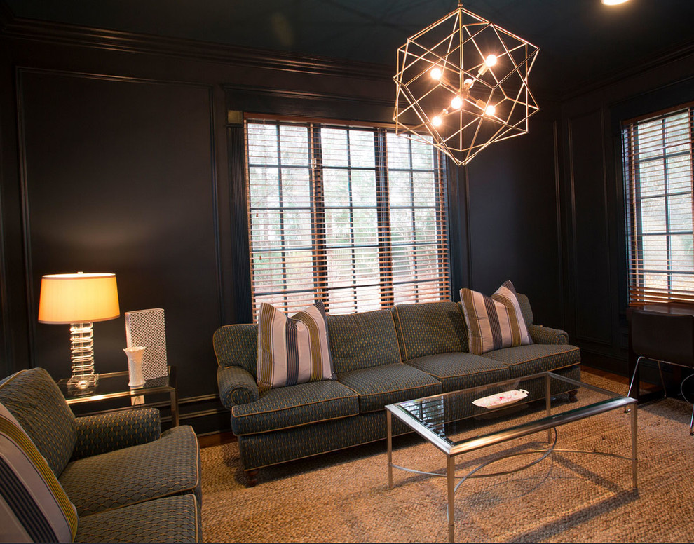 Example of a mid-sized trendy enclosed dark wood floor and brown floor family room design in New York with black walls