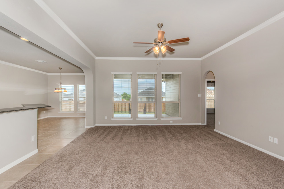 Medium sized traditional open plan games room in Austin with grey walls, carpet, no fireplace, no tv and beige floors.