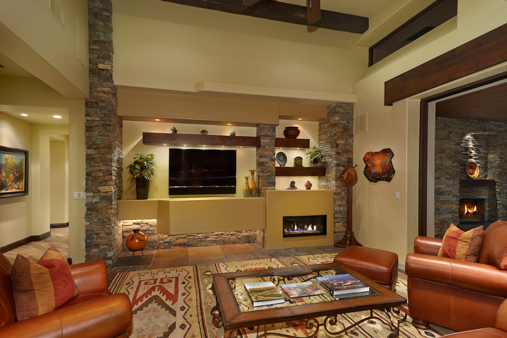 Medium sized open plan games room in Phoenix with beige walls, slate flooring, a standard fireplace, a metal fireplace surround and a wall mounted tv.
