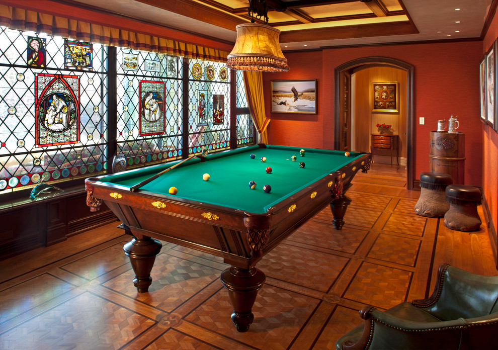 Photo of a traditional enclosed games room in Milwaukee with orange walls, medium hardwood flooring, no fireplace and no tv.