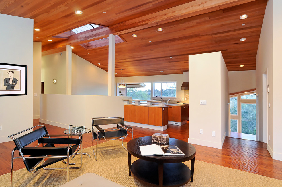 Inspiration for a large contemporary open concept medium tone wood floor and brown floor family room remodel in San Francisco with beige walls, no fireplace and no tv