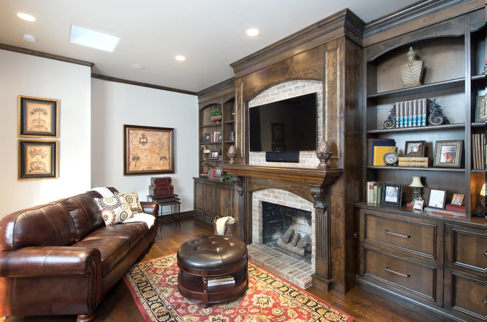 Mediterranean games room in Austin with white walls, dark hardwood flooring, a standard fireplace, a brick fireplace surround and a wall mounted tv.