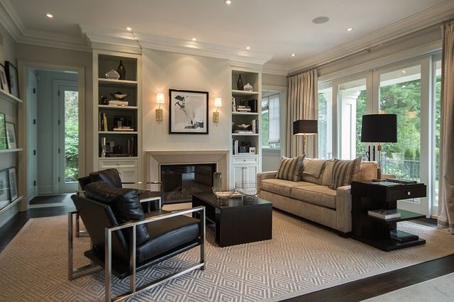 Immagine di un soggiorno chic di medie dimensioni e aperto con pareti beige, parquet scuro e camino classico