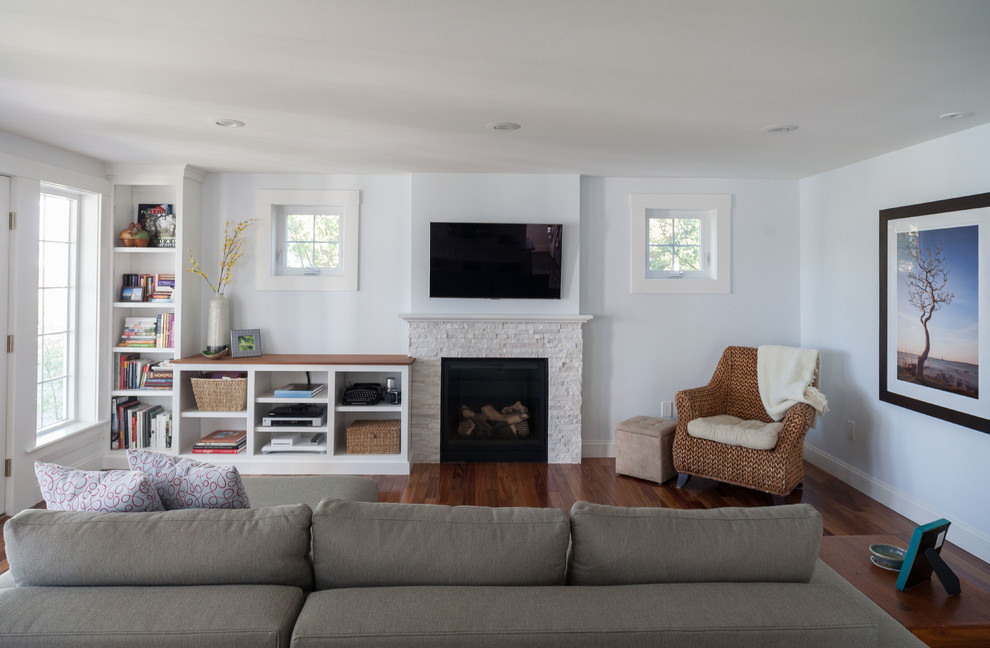 Design ideas for a medium sized nautical open plan games room in Boston with white walls, dark hardwood flooring, a standard fireplace, a stone fireplace surround, a wall mounted tv and brown floors.