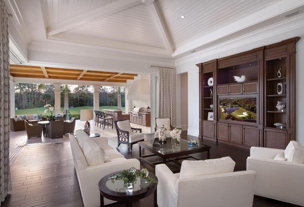 Family room - traditional open concept dark wood floor family room idea in Miami with gray walls and a media wall