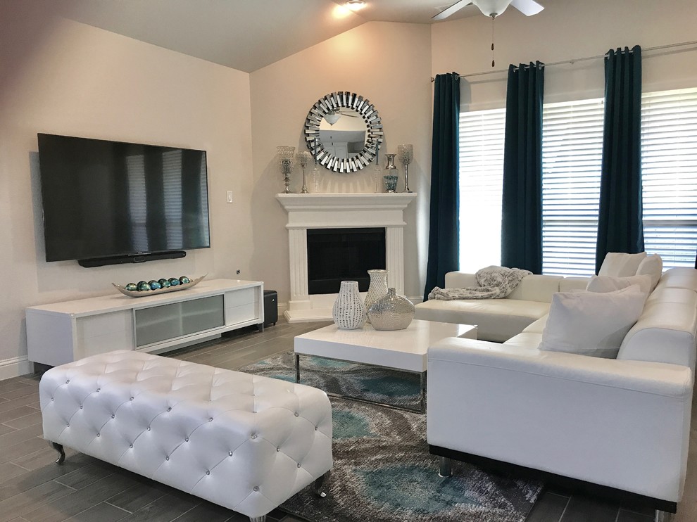 Design ideas for a medium sized contemporary open plan games room in Dallas with grey walls, porcelain flooring, a corner fireplace, a plastered fireplace surround, a wall mounted tv and grey floors.