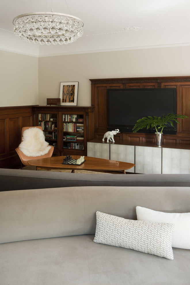 Example of a minimalist family room design in New York with beige walls and a wall-mounted tv